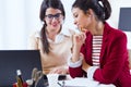 Two young businesswomen working with laptop in her office. Royalty Free Stock Photo