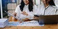 Two young businesswomen working new start up project Laptop computer and digital tablet and smart phone and discussing business Royalty Free Stock Photo