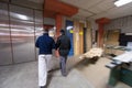 Two young carpenters working in big modern carpentry