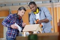 two young carpenters working in shop