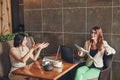 Two young caucasian businesswomen with laptop, notebook. Women in cafe Royalty Free Stock Photo