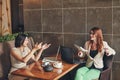 Two young caucasian businesswomen with laptop, notebook. Women in cafe Royalty Free Stock Photo