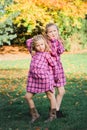 Two Young Caucasian Sisters Strike a Pose in Matching Pink Flannel Dresses Royalty Free Stock Photo