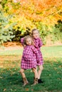 Two Young Caucasian Sisters Strike a Pose in Matching Pink Flannel Dresses Royalty Free Stock Photo