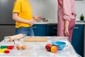 Two young Caucasian women cook together in the kitchen. Close up of worktop. The concept of LGBT couples and family cooking