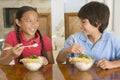 Two young children eating Chinese food Royalty Free Stock Photo