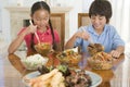 Two young children eating chinese food Royalty Free Stock Photo