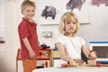 Two Young Children Playing Together at Montessori/ Royalty Free Stock Photo