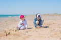 Two Young Children Playing Toys in the Sand Royalty Free Stock Photo