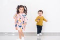 Two Young Children Running Towards Camera In Home. Royalty Free Stock Photo