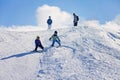 Two young children, siblings brothers, skiing in Austrian mountains on a sunny day