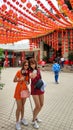 Two young Chinese girls take pictures in a traditional Chinese temple. New Years celebration