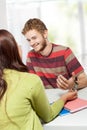 Two young college students studying together in class sitting Royalty Free Stock Photo