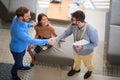 Two young confident men shacking hands while handsome woman is watching. business, deal, concept