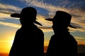 Two young cowboys silhouette wearing hats with a s Royalty Free Stock Photo