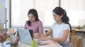 Two creative women in casual clothes sitting at modern office and working on project together. Royalty Free Stock Photo