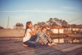 Two young cute little friends, boy and girl eating sandwiches and fishing on a lake in a sunny summer day Royalty Free Stock Photo