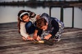 Two young cute little friends, boy and girl fishing on a lake in the evening Royalty Free Stock Photo