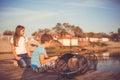 Two young cute little friends, boy and girl fishing on a lake in a sunny summer day Royalty Free Stock Photo