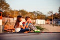 Two young cute little friends, boy and girl talking, drinking tea, eating sandwiches and fishing on a lake in a sunny summer day Royalty Free Stock Photo