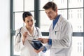 Two young dedicated doctors analyzing together a radiograph