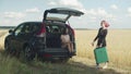 Two young diverse women with suitcases on car trip