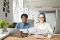 Two Young Editors at Desk in Publishing Office