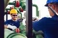 Two engineers working inside oil and gas refinery Royalty Free Stock Photo