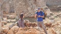 Two young archaeologists exploring ancient city