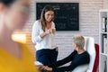 Two young entrepreneur women drinking coffee and taking a break in the office Royalty Free Stock Photo