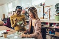 Young entrepreneur women, or fashion designers working in atelier and making short breakfast break at work Royalty Free Stock Photo
