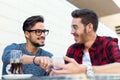 Two young entrepreneurs working at coffee shop. Royalty Free Stock Photo