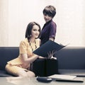 Two young fashion business women with file folder at office Royalty Free Stock Photo