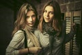 Two young fashion girls next to brick wall Royalty Free Stock Photo