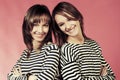 Two young fashion girls in a striped shirts