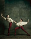 Two young female ballet dancers like duelists with swords. Ballet and contemporary choreography concept. Creative art Royalty Free Stock Photo