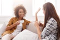 Two young female friends with coffee conversing Royalty Free Stock Photo