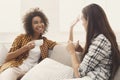 Two young female friends with coffee conversing Royalty Free Stock Photo