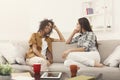 Two young female friends with coffee conversing Royalty Free Stock Photo