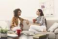 Two young female friends with coffee conversing Royalty Free Stock Photo