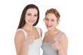 Two young female friends gesturing thumbs up Royalty Free Stock Photo
