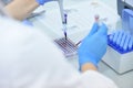 Two Young Female and male Laboratory scientists working at lab with test tubes and microscope, test or research in clinical Royalty Free Stock Photo