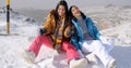 Two young female snowboarders enjoying a chat Royalty Free Stock Photo