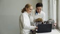 Two young fencers man and woman watching fencing tutorial on laptop computer and sharing experience before training