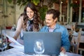 Two young freelancers looking over documents while working in a cafe Royalty Free Stock Photo