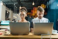 Two young freelancers working hard while sitting in cafe Royalty Free Stock Photo