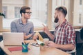 Two young freelancers working online on project plans best friends talking having conversation in cafe looking at each other gestu Royalty Free Stock Photo