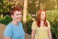 two young friends having a lively conversation in a public park. young girls in the city gesticulating while gossiping Royalty Free Stock Photo