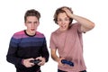 Two young friends playing video games and holding gamepads. Tourney or tournament concept Royalty Free Stock Photo