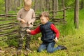 Two young friends playing in woodland Royalty Free Stock Photo